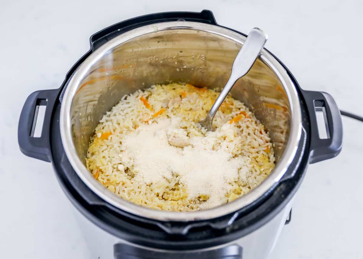 Stirring cheese into rice in instant pot.