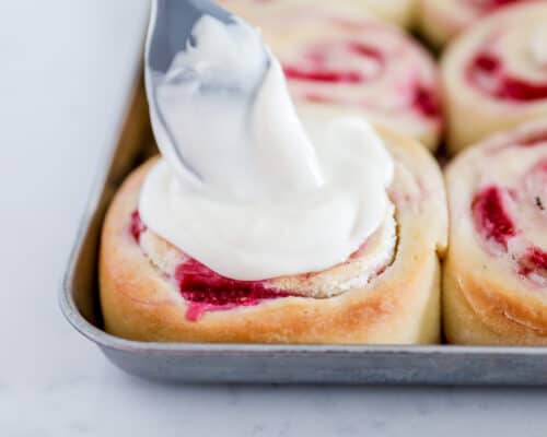 pouring glaze on top of sweet roll