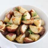 roasted potatoes in white bowl