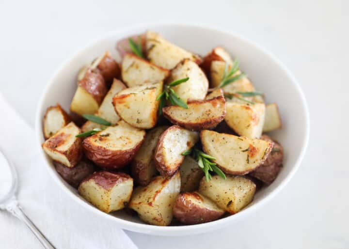 roasted potatoes in white bowl