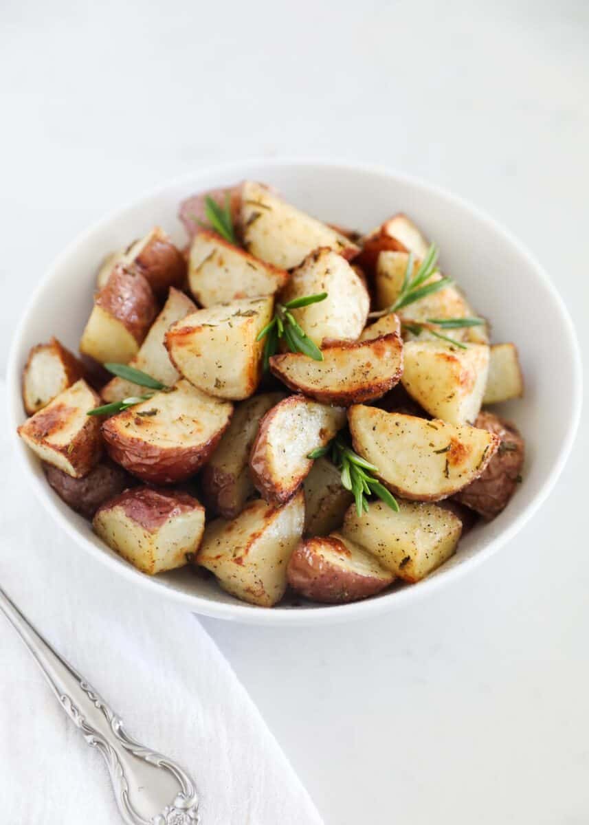 rosemary roasted potatoes in white bowl