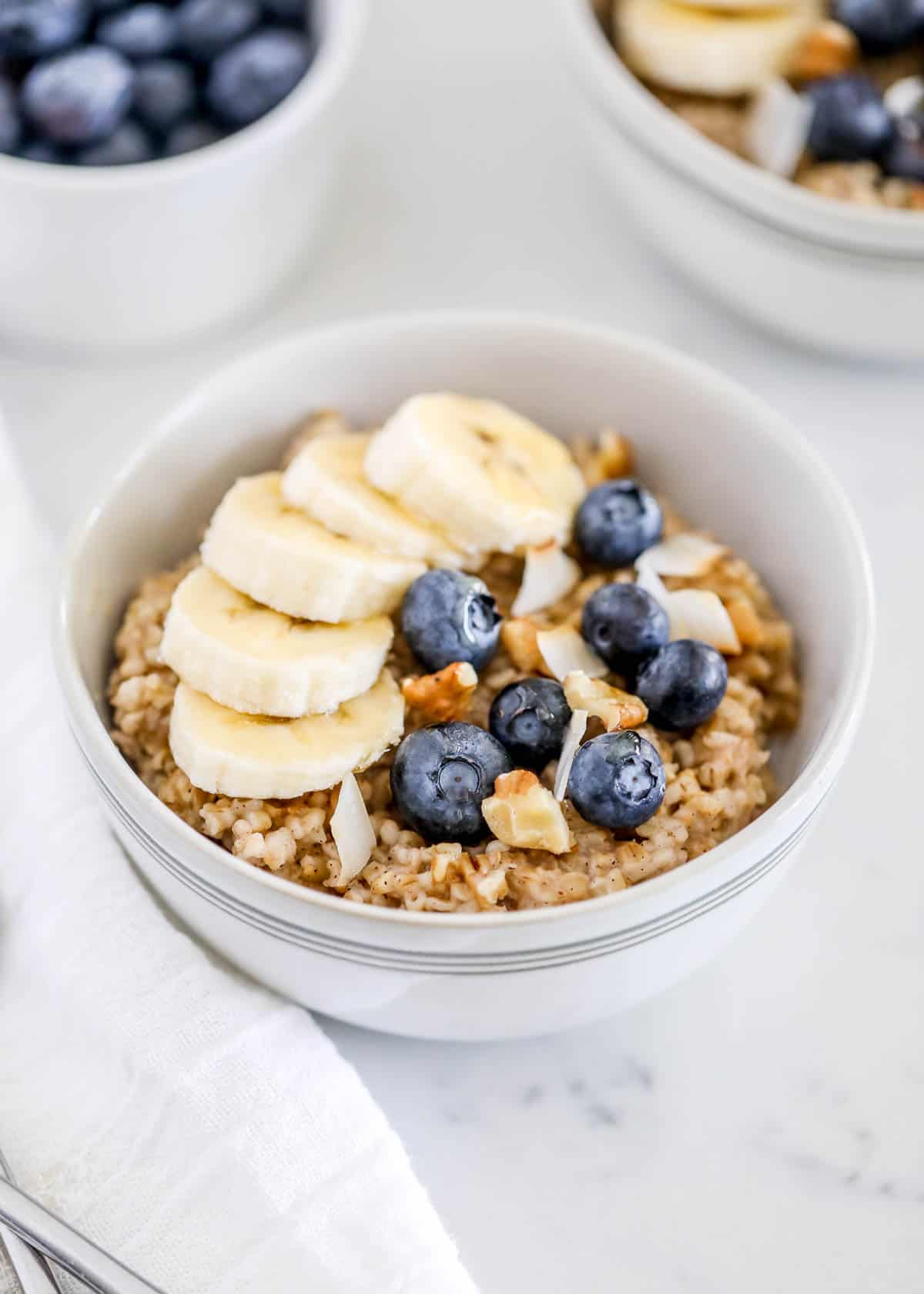 Bowl of steel cut oats with blueberries and bananas.