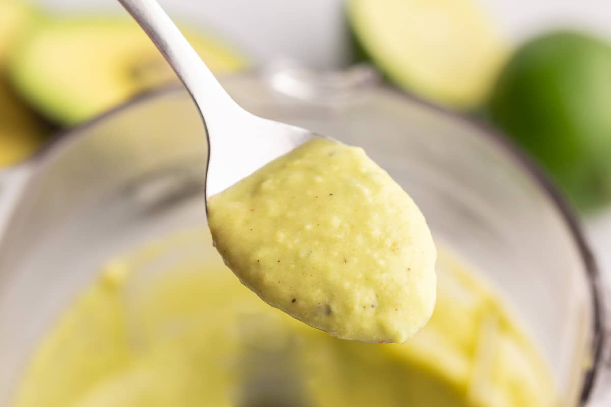 Spoonful of avocado lime dressing.