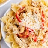 creamy chicken pasta with peppers on white plate