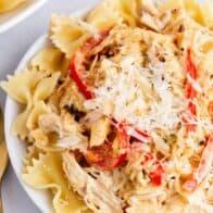 creamy chicken pasta with peppers on white plate