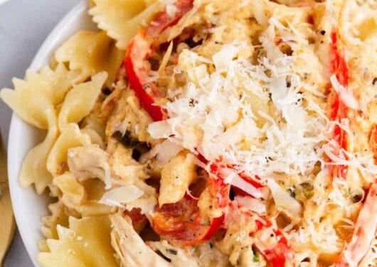 creamy chicken pasta with peppers on white plate