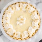 Easy banana cream pie sitting on marble countertop.