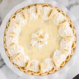 Easy banana cream pie sitting on marble countertop.