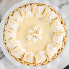 Easy banana cream pie sitting on marble countertop.