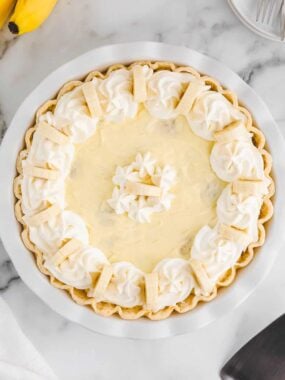 Easy banana cream pie sitting on marble countertop.