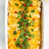 green chile chicken enchiladas in casserole dish