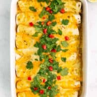 green chile chicken enchiladas in casserole dish