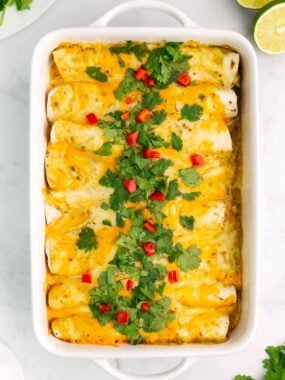 green chile chicken enchiladas in casserole dish