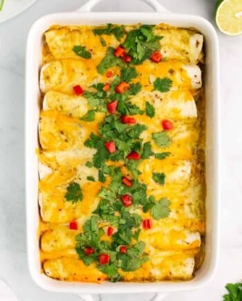 green chile chicken enchiladas in casserole dish