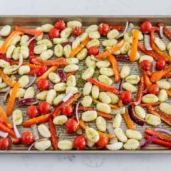 Sheet Pan gnocchi with gnocchi and vegetables tossed with pesto on one pan.