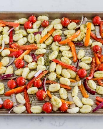 Sheet Pan gnocchi with gnocchi and vegetables tossed with pesto on one pan.