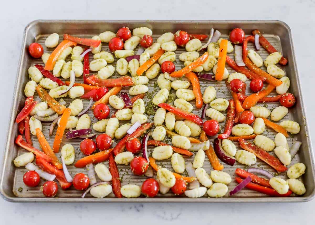 This sheet pan gnocchi is perfect for a last-minute dinner or side dish. The gnocchi becomes crispy and the vegetables are roasted to perfection. Sheet Pan gnocchi with gnocchi and vegetables tossed with pesto on one pan.
