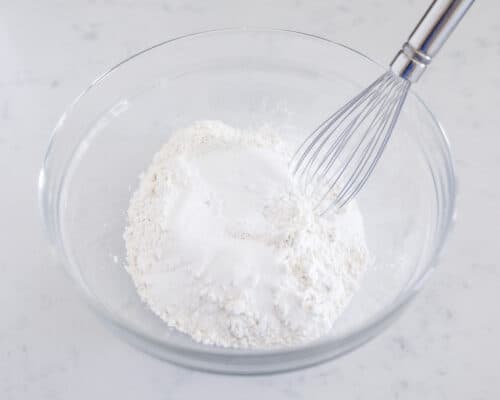 whisking flour in glass bowl