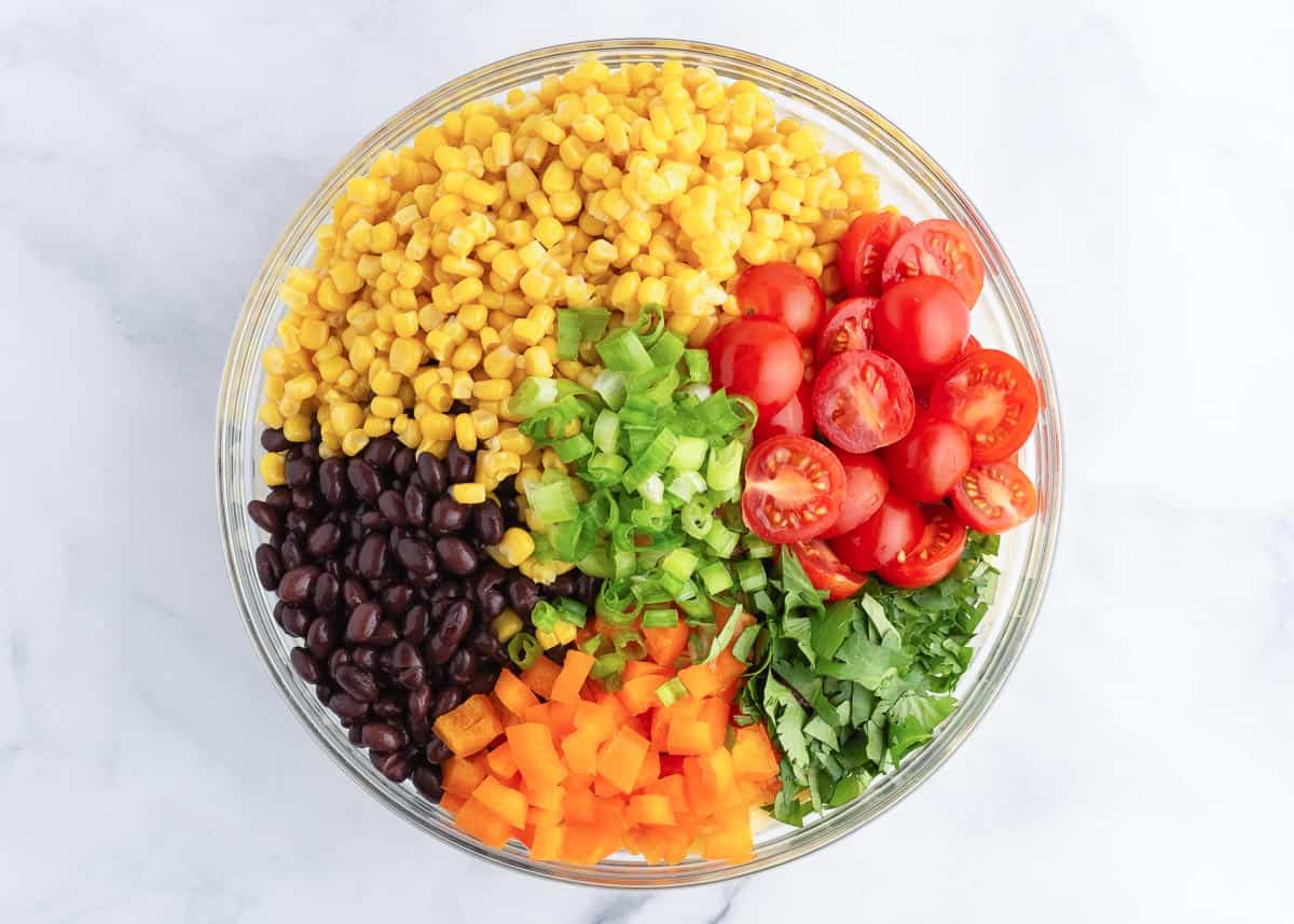 Pasta salad ingredients in bowl.