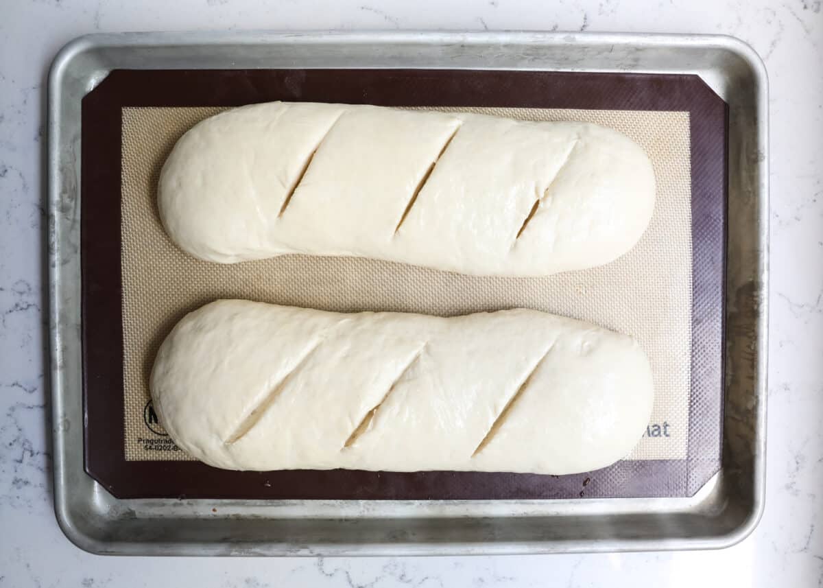 French bread loaves on pan ready to bake