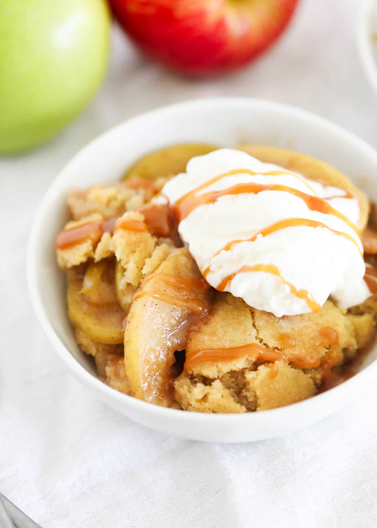 Apple cobbler with ice cream and caramel sauce.