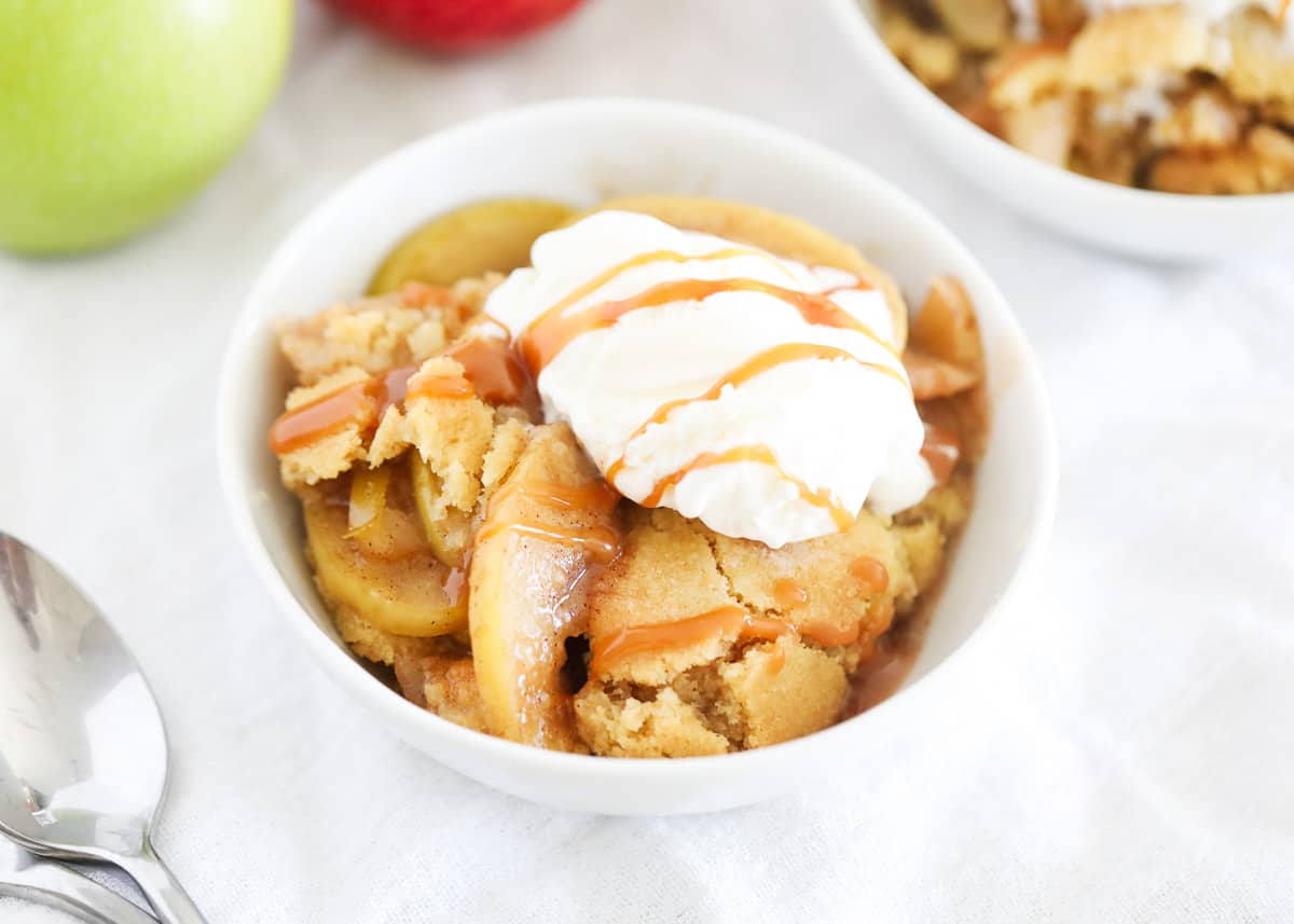 This easy apple cobbler recipe has a caramelized apple filling cooked down in a sugar-cinnamon syrup topped with a buttery sweet cobbler topping that is just heavenly! So simple yet so delicious! Apple cobbler with ice cream on top.