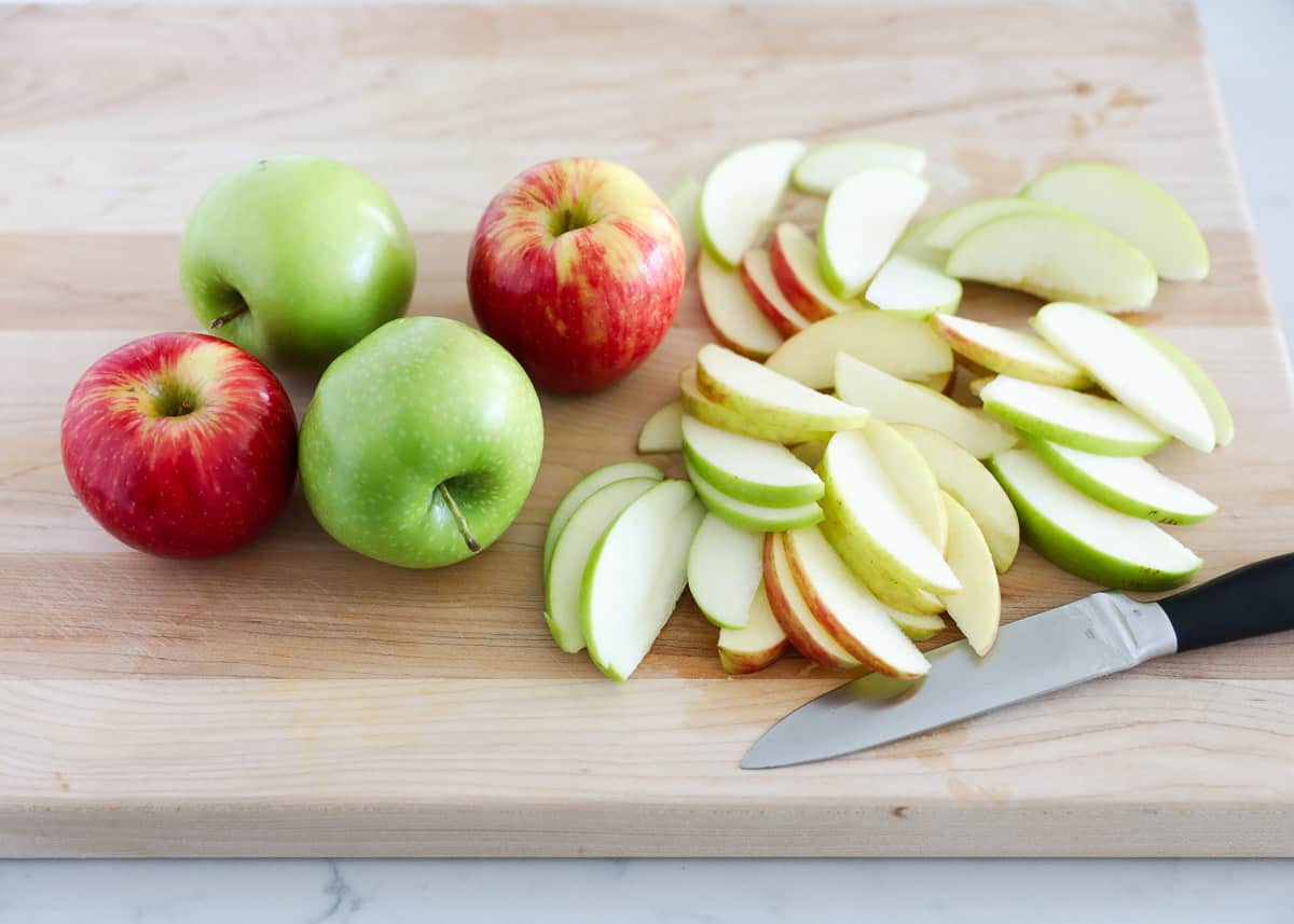 Sliced apples on cutting board.