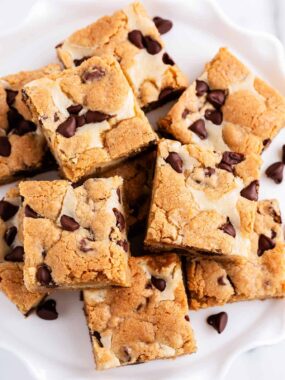 cheesecake cookie bars stacked on plate