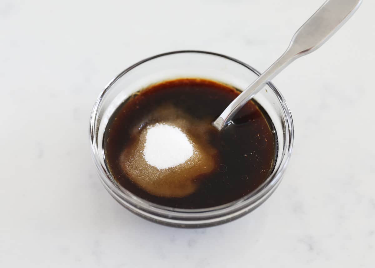Mixing chow mein sauce in a small bowl.