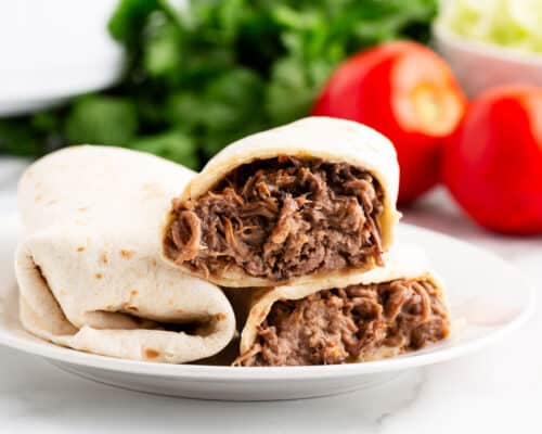 green chili burritos on white plate