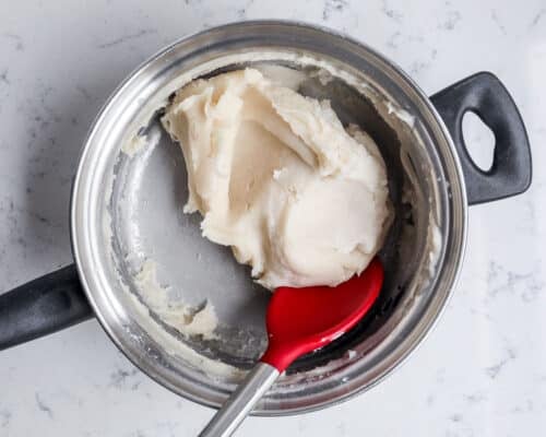 mixing together play dough in pan