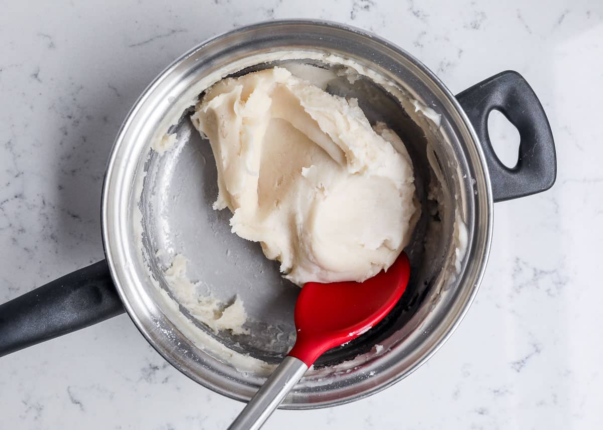 mixing together play dough in pan