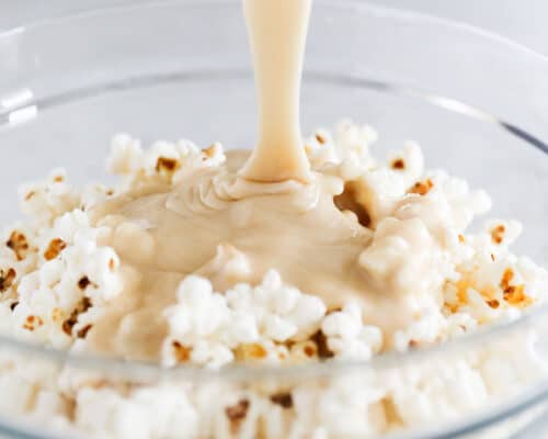 pouring caramel into popcorn