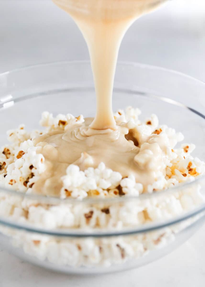 pouring caramel into popcorn