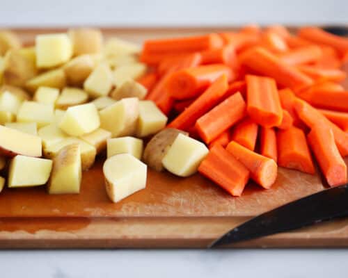 potatoes and carrots on cutting board