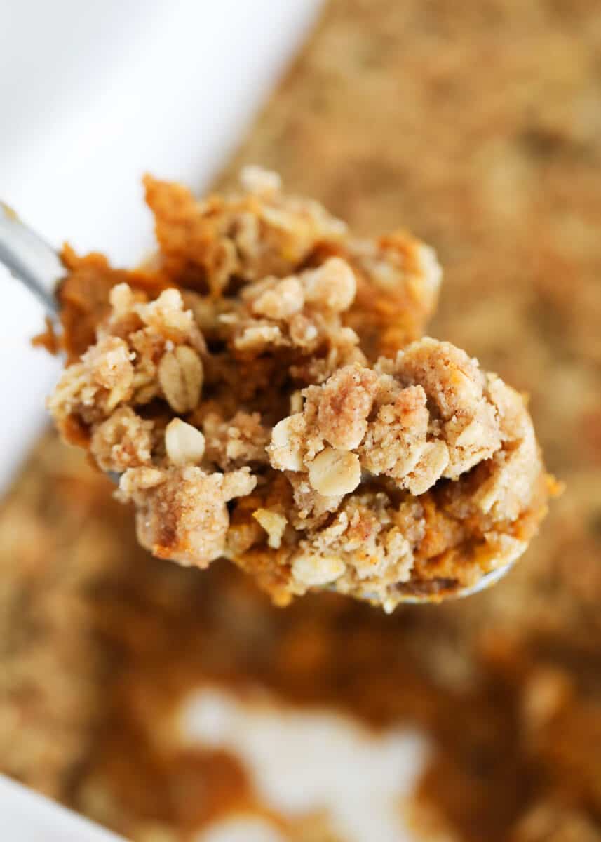 spoonful of pumpkin crisp in white dish