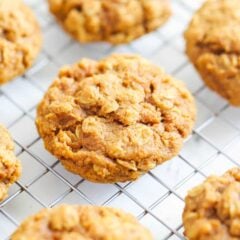 Close-up of chewy pumpkin oatmeal cookies cooling on a wire rack.