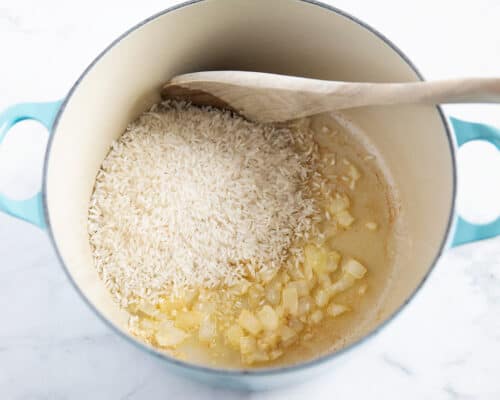 cooking onions and rice in pot