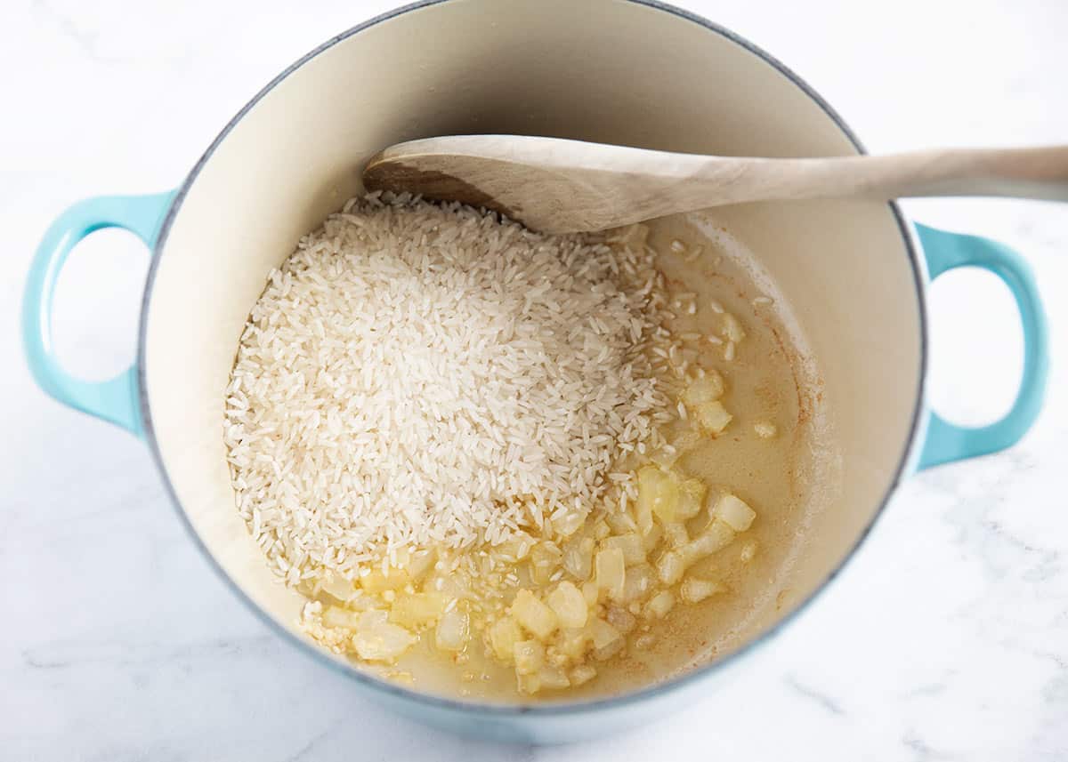 cooking onions and rice in pot