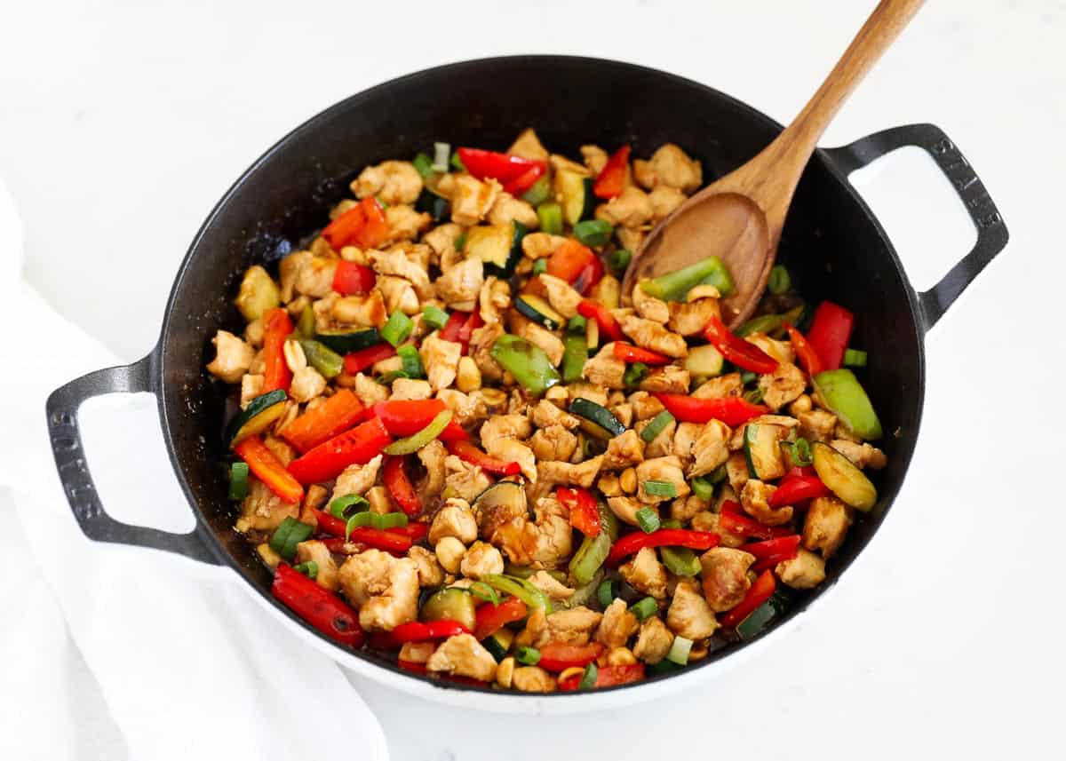 Kung Pao chicken in a black skillet. 