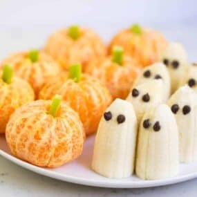 Pumpkin tangerines and ghost bananas are healthy Halloween snacks that kids love.