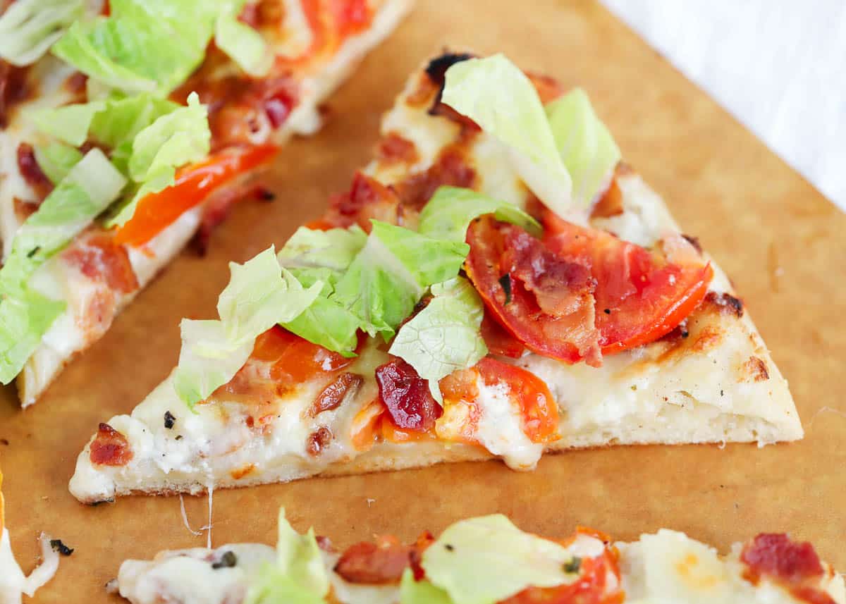 Slice of BLT pizza on pizza peel