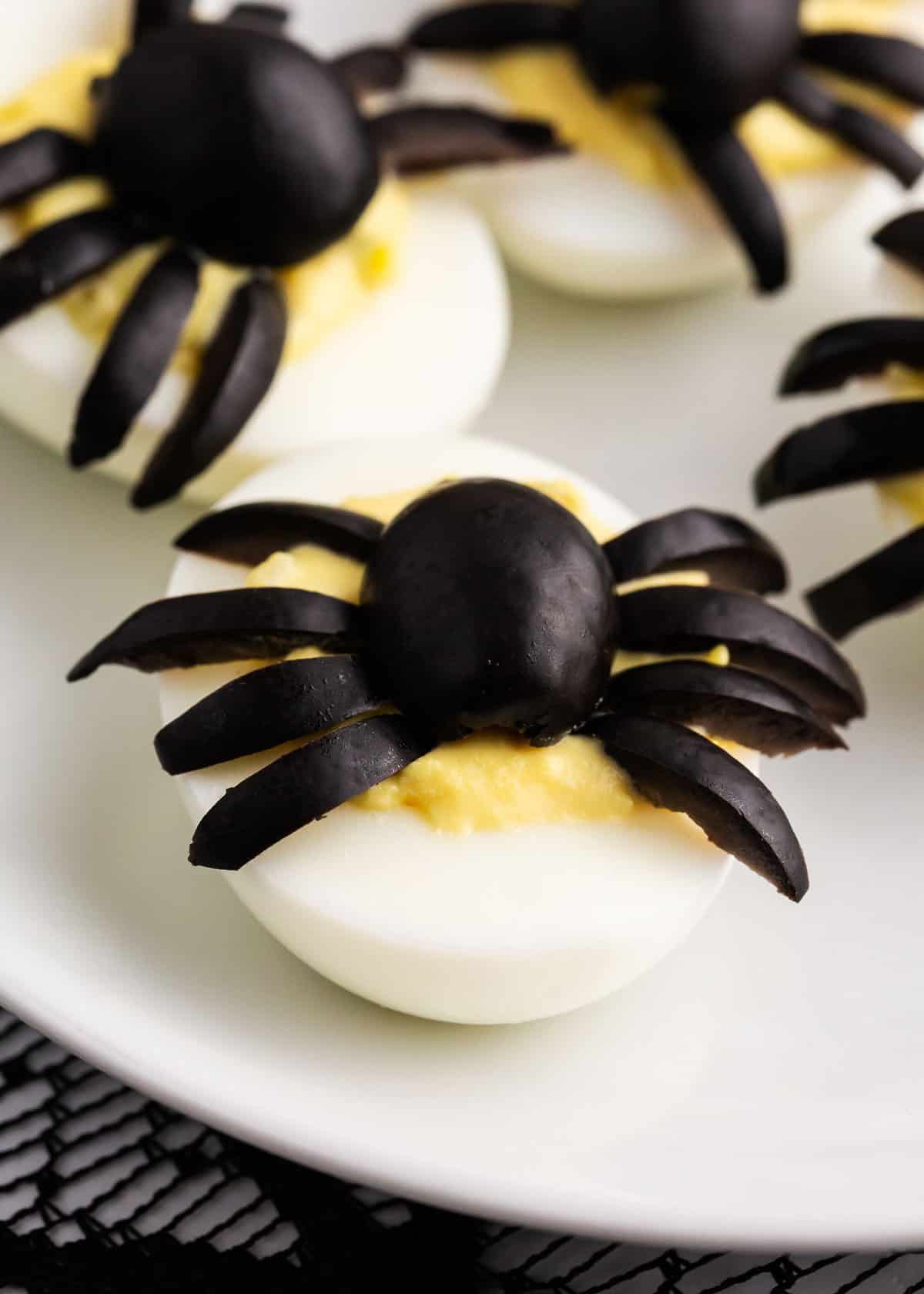 spider deviled egg on white plate