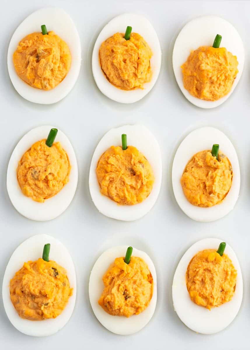 pumpkin deviled eggs on white plate