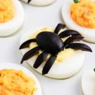 Halloween deviled eggs on white plate