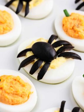 Halloween deviled eggs on white plate