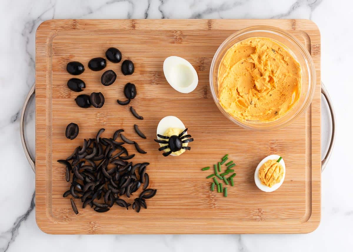 halloween deviled eggs on wooden board