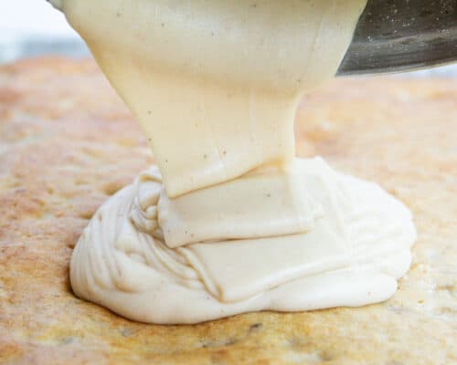 pouring brown butter frosting on cake