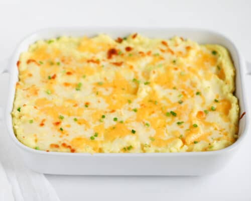 cheesy mashed potatoes in white baking dish