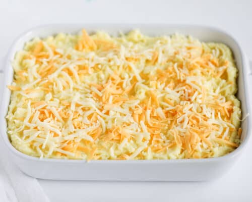 cheese on top of potatoes in baking dish